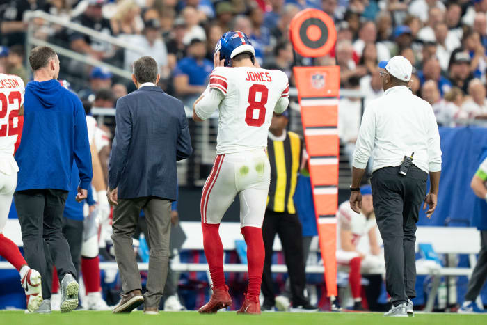 Giants quarterback Daniel Jones walks to the sideline after suffering a torn Achilles against the Raiders during the second quarter Sunday at Allegiant Stadium.